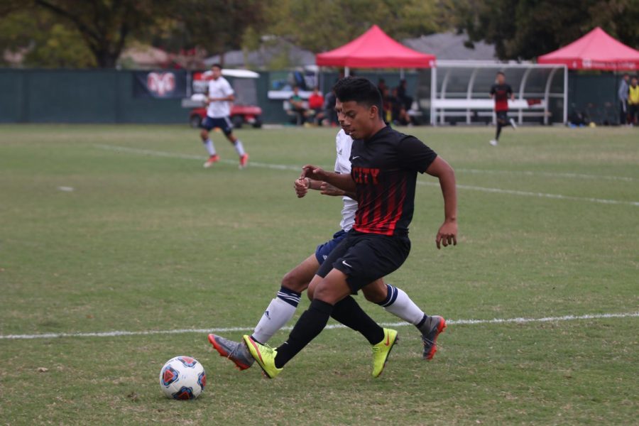 Fresno City College midfielder Julian Yepiz covers the ball from an opponent during a match against College of the Sequoias on Friday, Nov. 3, 2017.