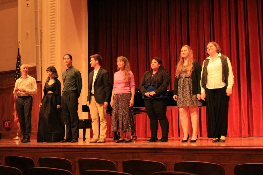 (Left to Right) Aarne Kela, Nhi Nguyen, Ryan Fromuth, Tanner OBrien, Jenince Bourdase, Mia Alvarez, Bernadette LaMontagne-Schneck and Gena Chambers stand before event attendees on stage.