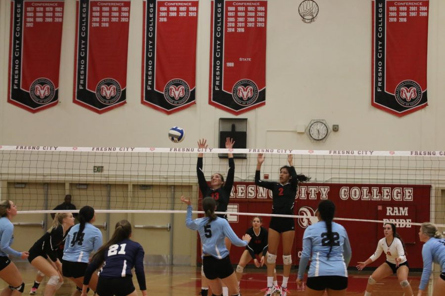 Fresno City College middle blocker Abbey Briggs and outside hitter Makayla Cervantes jump to make a block during a game against Cerro Coso Community College on Friday, Nov. 3, 2017.