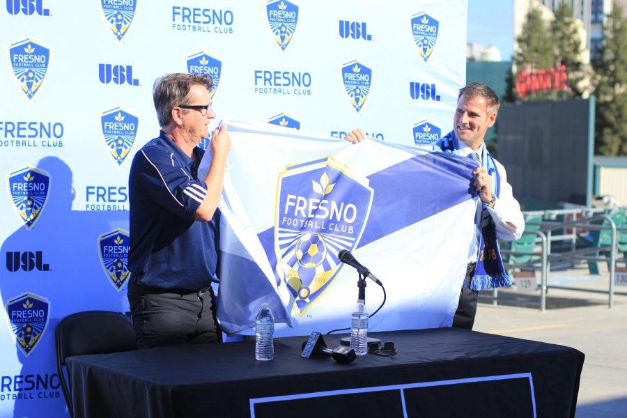 General Manager Frank Yallop (left) and Head Coach Adam Smith (right) hold a Fresno FC flag during the official presentation of Smith as head coach at the Chuckchansi Park on Thursday, Nov. 9, 2017.