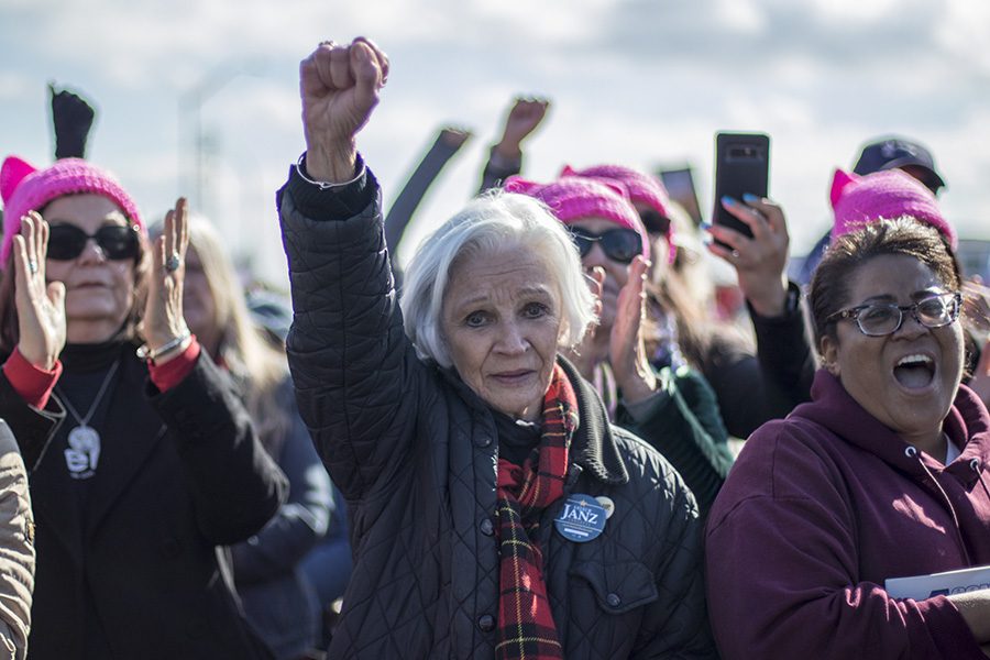 Patricia Johnson raises her fist in protest at the Womens March in Fresno River Park area on Saturday Jan. 20, 2018. 