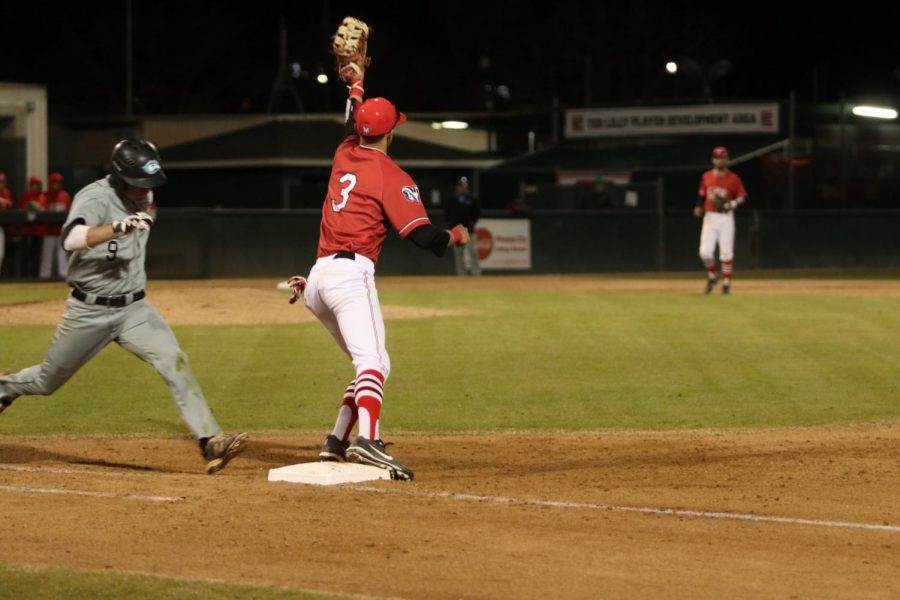 Sophomore first baseman Jacob Paradine with a forceout at first and following up his defense with a homerun on Friday, Feb.23,2018. Photo by Larry Valenzuela.