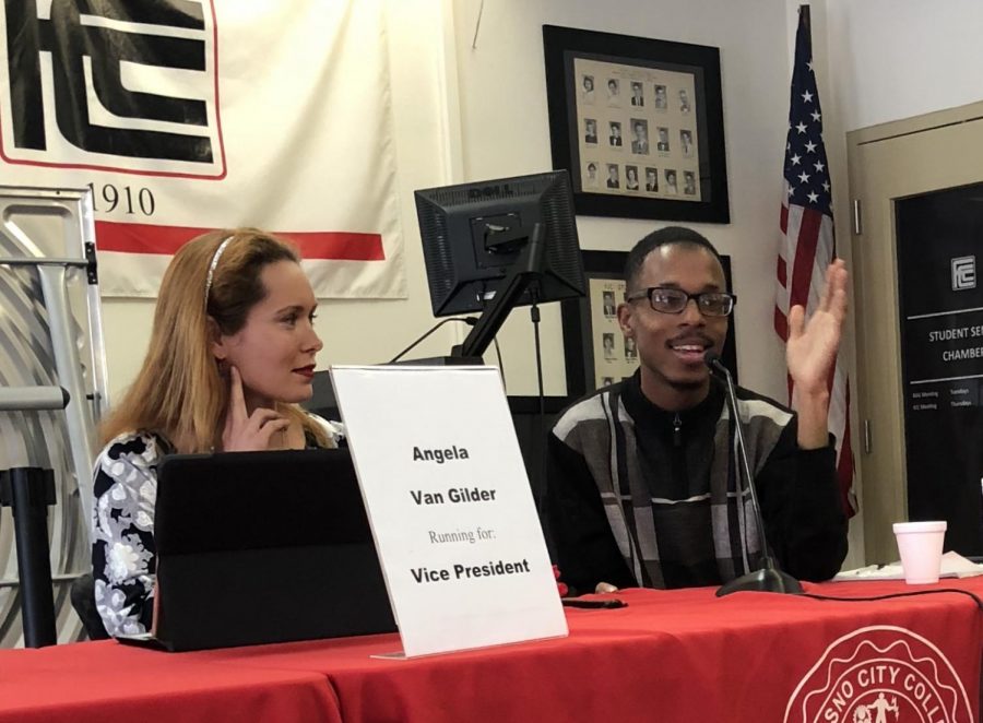 Angela Van Gilder (left), running for a vice president, and Christopher Washington, running for president, speak to students in the Student Lounge on Wednesday, April 18, 2018. 