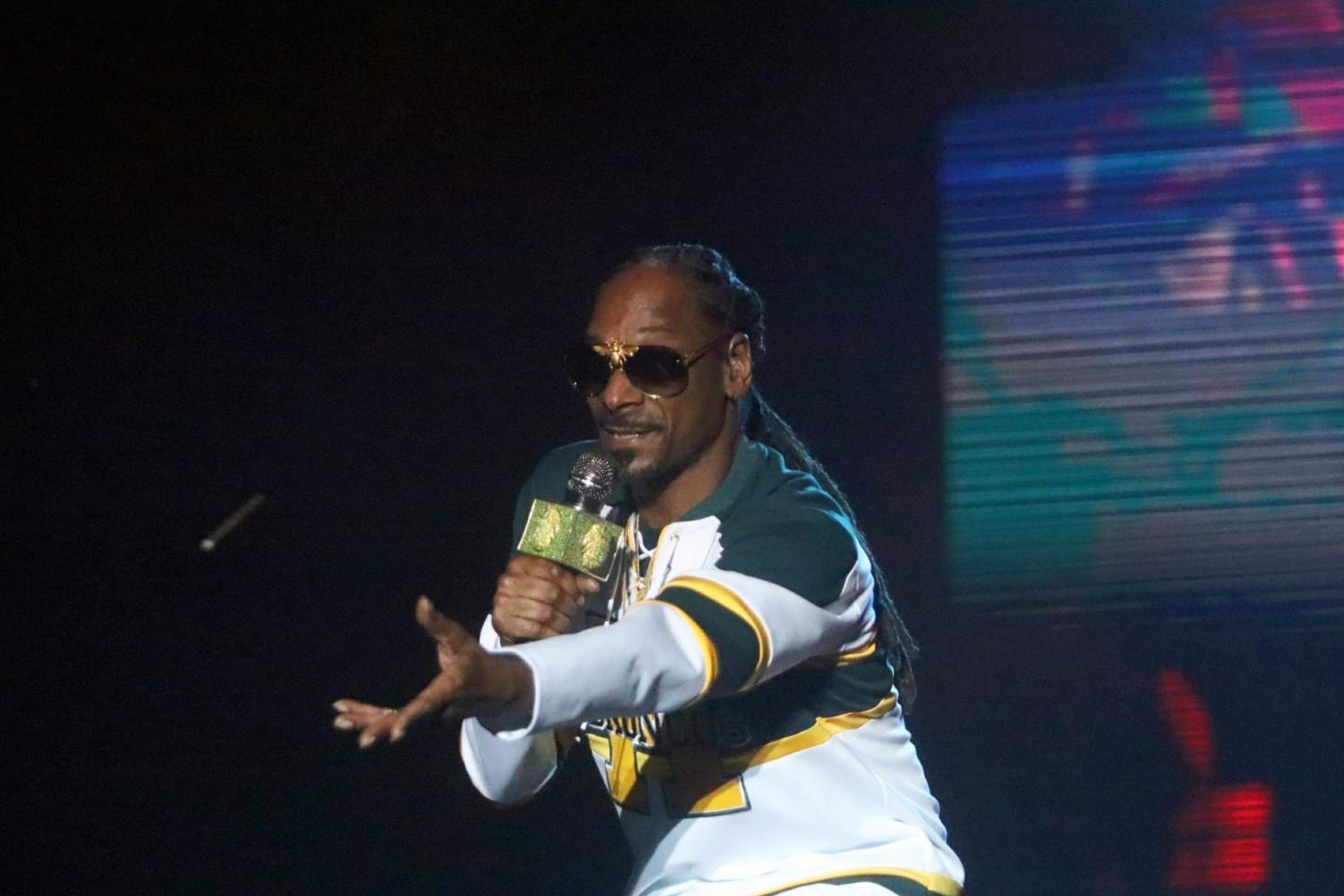 Rapper Snoop Dogg throws a blunt to members of the crowd as he headlines on the Yosemite stage on day two of Grizzly Fest, Friday, May 18.