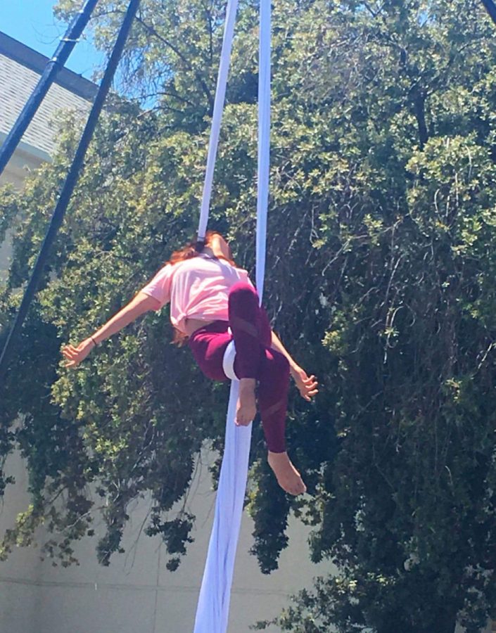 An aerial silk artist performs at the Fresno High Memorial Day Block Party, May 28, 2018. 