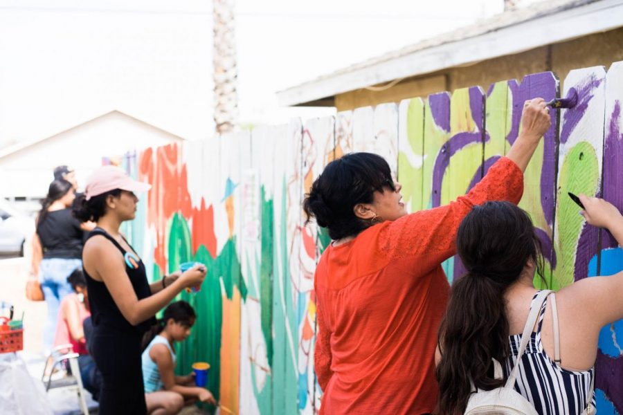 MPWR block party guests assist in a mural-painting effort on Sunday, Sept. 30 2018 in south-east Fresno.