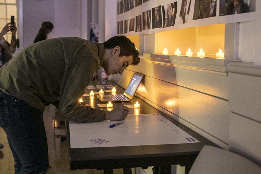 Daniel Lopez signing a card for the victims of transgender violence during Transgender Day of Remembrance Vigil held in the Old Administration Building room 114 on Tuesday, Nov. 20, 2018. 