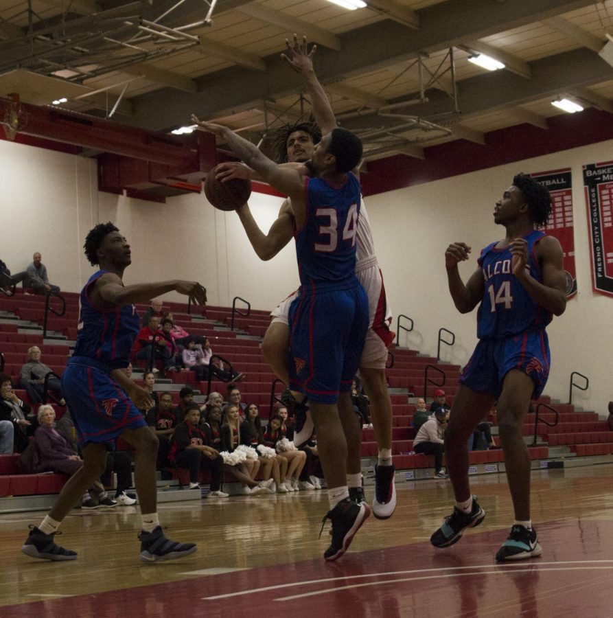 Sophomore guard Jared Small fights through the defense of West Hills Coalinga during 81-60 win on Monday, Feb. 4. Photo by Ben Hensley