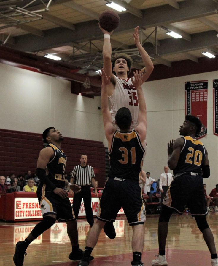 Sophomore forward Ethan Richardson battles three defenders going up for the shot against Reedley College on Feb. 20, 2019.