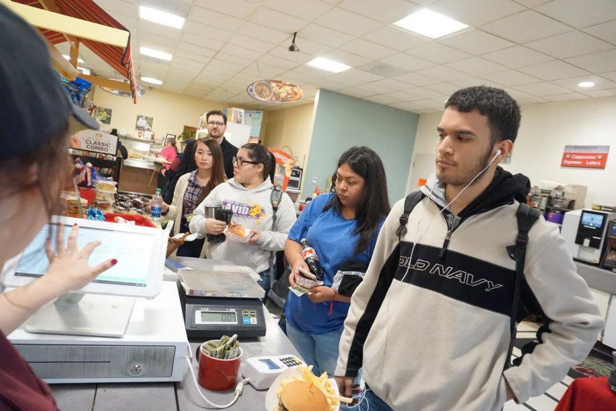 Students line up to buy food at the cafeteria on campus with their meal cards and coffee cards at Fresno City College. 