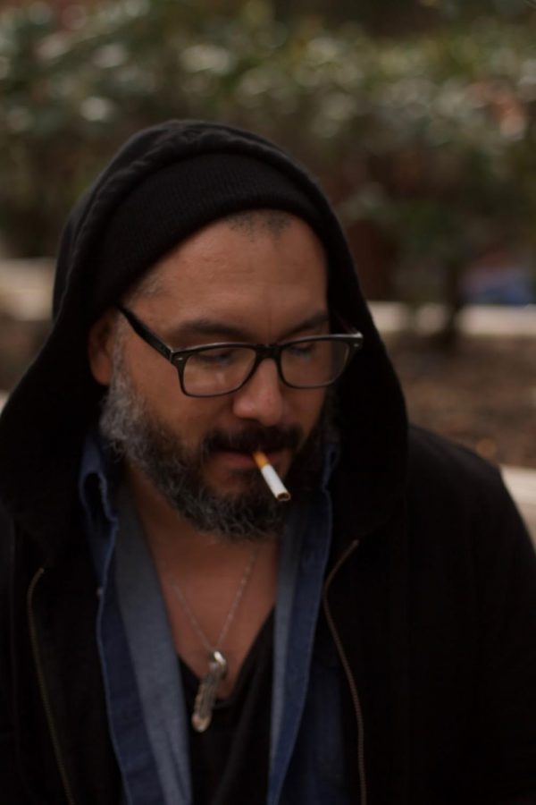 Music major Ray Silva, 36, smoking natural tobacco to relieve stress in FCCs designated smoking area.