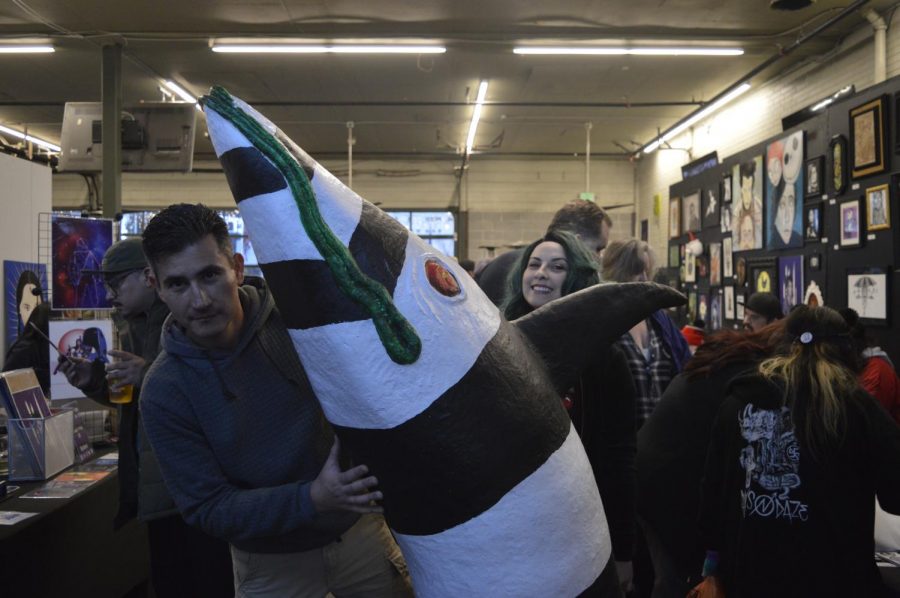 David and Caroline Vicchio prepare their 5 tall sandworm at Tioga Sequoia Brewing at a Tim Burton art Tribute on Saturday March 2.