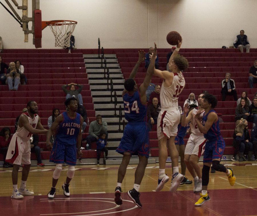 Ethan Richardson fends off the defense with one arm while shooting with the other during the Rams 81-60 victory against West Hills Coalinga on Feb. 4, 2019.