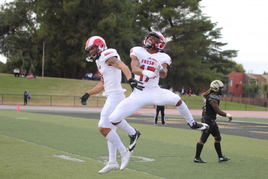 Austin Aukia (left) and Milton Clements (right) celebrate a touchdown on Oct. 19, 2019