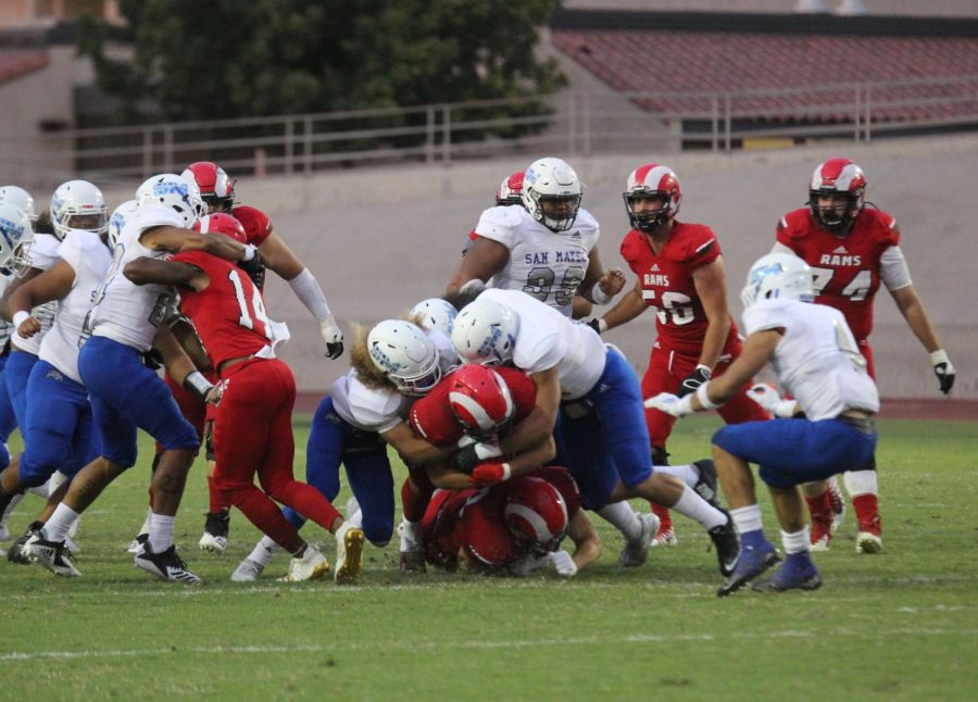 Rams sophomore running back Rico Rosario pounds the ball ahead during the Rams 17-3 loss against the San Mateo College Bulldogs. The loss was the first of the Rams 2019 season.