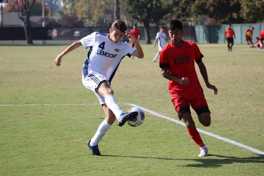 Sophomore midfielder Alex Echevierra racing for an attack on goal against West Hills Lemoore defender Pete Hawken on Tuesday, Nov. 5, 2019