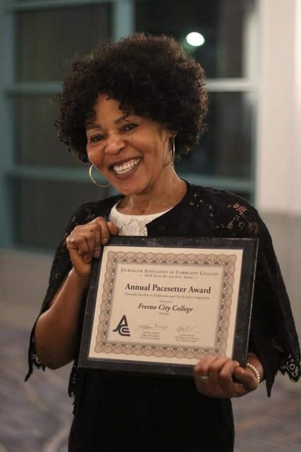 Dympna Ugwu-Oju, Rampage adviser, holding an annual pacesetter award from the Journalism Association of Community Colleges. During her tenure as adviser, the Rampage has taken this award home several times.