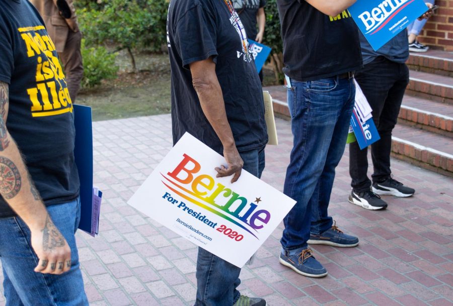 A Bernie Sanders supporter holds a rainbow Bernie for President 2020 sign while attending the March to the Polls event held at Fresno City College on Monday, March 2.