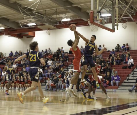 Sophmore guard Jeshawn Bruner powers through freshman wing Alex Rojas during the Rams win over Mendocino on Saturday March 7.