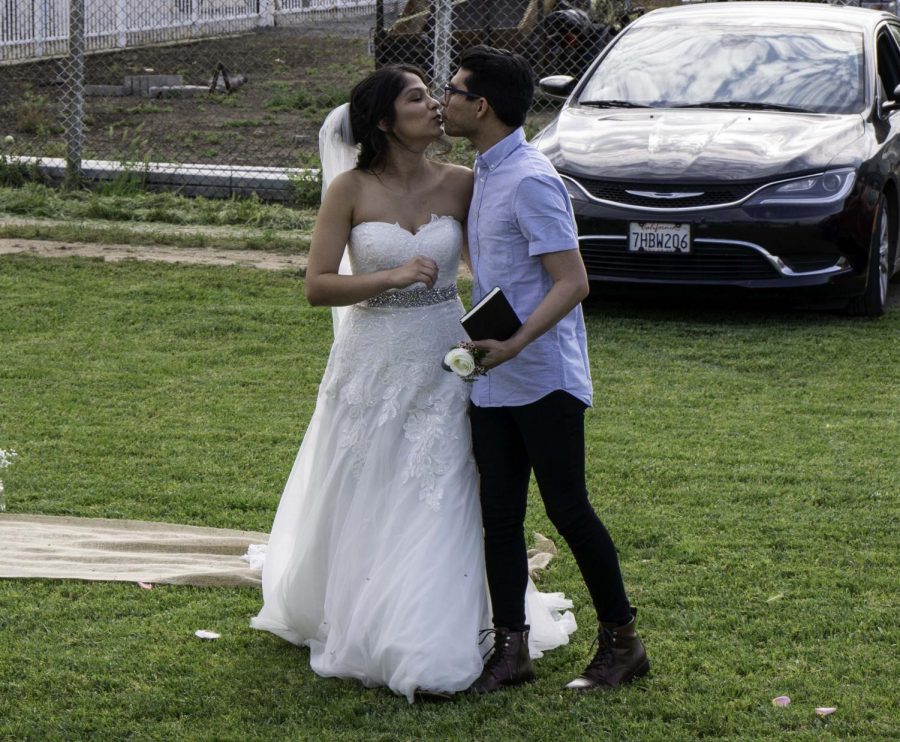 The newly wedded Ethan and Alyssa Larios share a kiss on April 17.