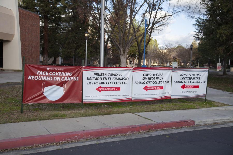 Signs requiring face covering line the edge of the FCC campus.