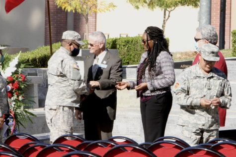 State Center Community College District Interim Chancellor Douglas Houston (left), FCC Vice President of Student Services, Lataria Hall, (middle) and FCC Vice President of Instruction Don Lopez (right) gifting veterans a special pin to wear. 