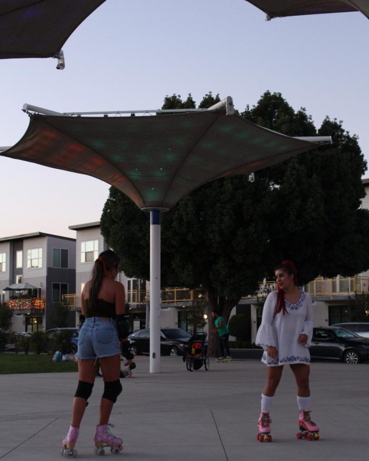 Isabel Dieppa (right) skating with a friend at downtown Fresnos  cultural arts district park. 