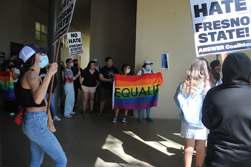 Posters and flags raised during the "No Hate at Fresno State" protest where many gathered to speak their voice.