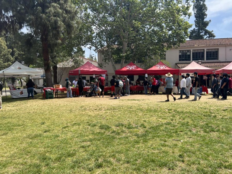 students gather around club booths