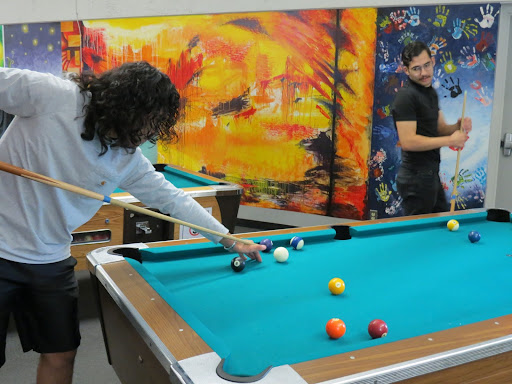 Business and Real Estate major Johnathan Areyaho (left) and Paralegal major Artur Asatryan (right) in the middle of a game of pool in the FCC game room on September 1. 

