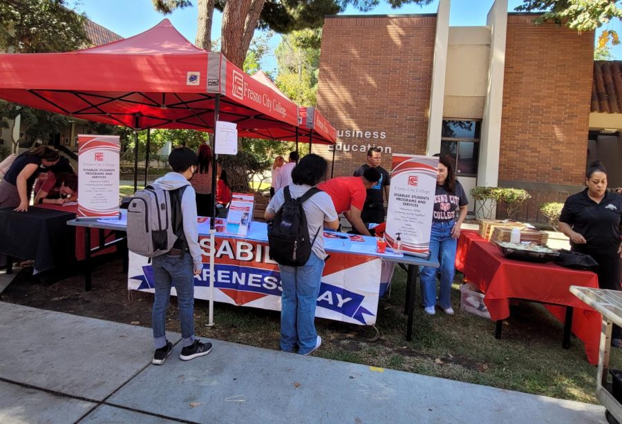 Disability Awareness booth serving pizza and drink to staff and faculty in support of Disability Awareness Day on Oct. 5. 