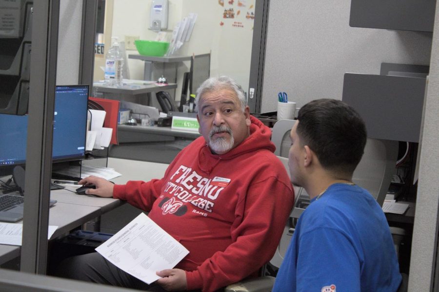 Career Counselor Jesse Llanos talking with Fresno City College Student Alan Ramirez, major undecided, about his career assessment results and interest for the future on Nov. 22, 2022.
