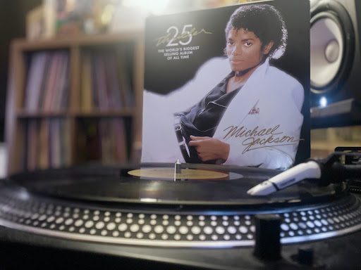A picture of Michael Jacksons Thriller  25th Anniversary Vinyl Record being played on a turntable.  