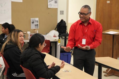Fresno City College foreign language professor Etienne Harvey teaches American Sign Language to students Angela Chantharath (left), and Edith Lievanos (right) on March 16, 2023.