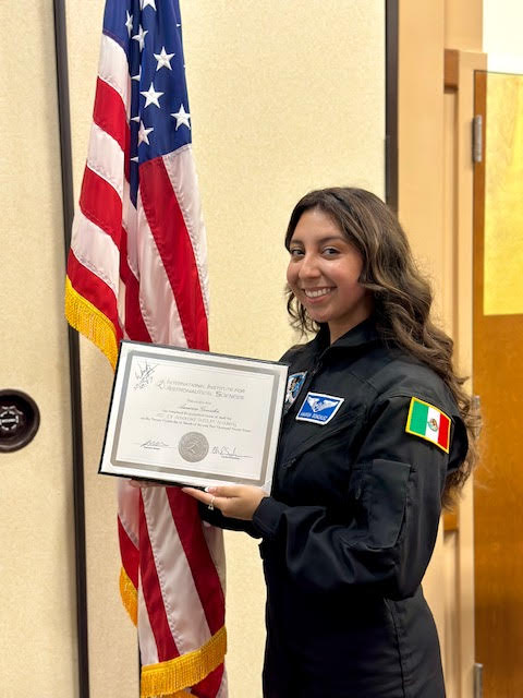 Amarisa Gonzalez with her certificate for completing the poSSUM program at the top of her class at the Florida Institute of Technology in Melbourne March 24, 2023