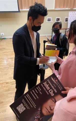 John Cho speaking with students and signing autographs after his speakers forum speech on April 18.