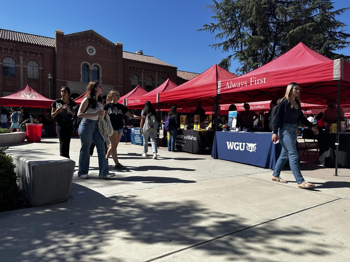 Students navigate through University Mall at Fresno City College for Transfer Day. Booths are set up with university and college representatives who explain what their school has to offer on Sept. 13, 2023.
