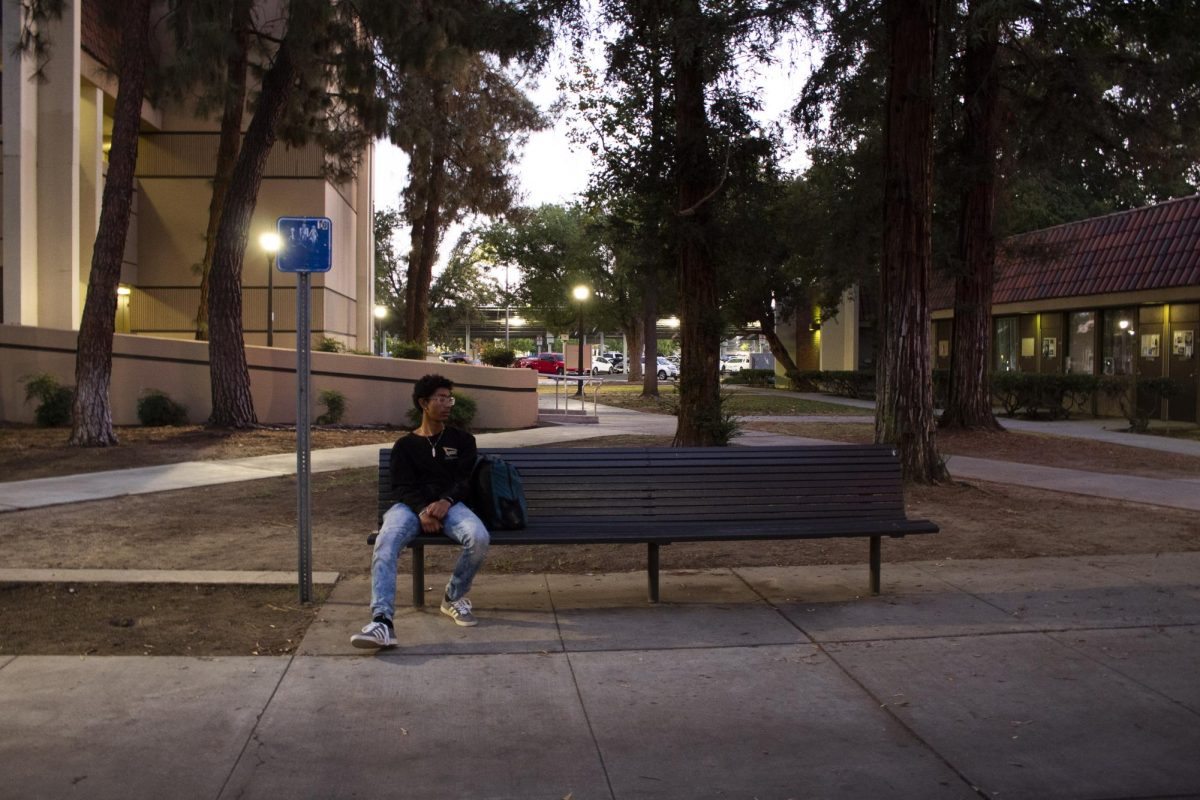 Aiden Cardenas, an engineering major, waiting for his friend to get out of class in front of the science and development center on the evening of Oct. 19, 2023.