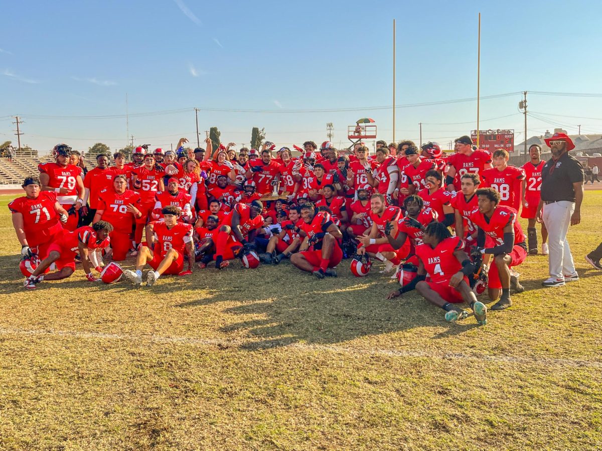 Fresno City College Rams pose with the pump after beating their rivals, the Reedley College Tigers.