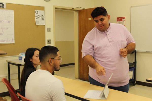 Deaf faculty member and foreign language professor Salvador Garcia instructs students Sergio Suarez, ASL interpreting major and Emily Vang, speech language pathology major on Nov. 27.