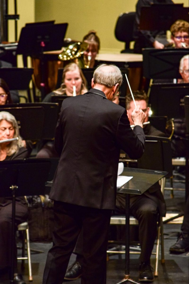 Conductor Bruce Weinberger conducting during a song. January 20, 2024.