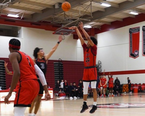Mike Sarden #23 making a jump-shot from the three-point line in the Fresno City College Gym 
