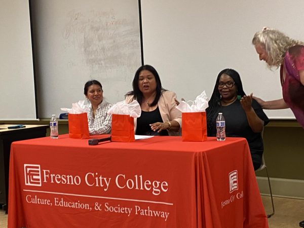 (Left to Right) Liset Garcia, Marjorie Carlet-Edmonds, and Devoya Mayo receive gift bags on behalf of Fresno City College as they finish up the panel discussion.
