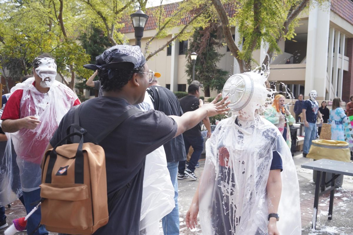 Fresno City College student pies faculty members during the Pi Day
fundraising event on March 15.