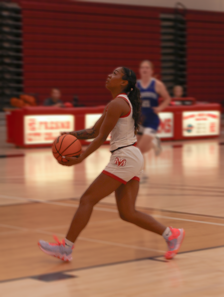 Archive: Madison Johnson, #3, goes in for the layup against Madera City College.