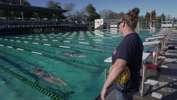 Fresno City College women’s water polo and swim and dive, Head Coach Hilary Boos, and her players doing laps in the pool at their practice on Mar. 14, 2024.