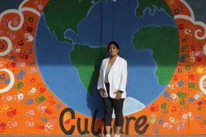 Professor Harinder Kaur Rai poses in front of an art mural at Central East High
School on March. 28, 2025.