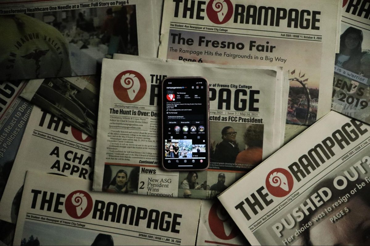 An iPhone displaying the official Rampage Instagram account rests on top of several Rampage print newspapers on May 19, 2025.