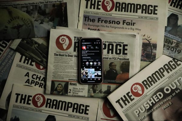 An iPhone displaying the official Rampage Instagram account rests on top of several Rampage print newspapers on May 19, 2025.