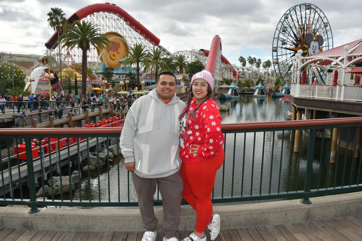 (Left) Joe Maya, Alyssa’s husband, and Alyssa Bustamante pose for a photo in front of Pixar Pier on Dec 2, 2022. Photo contributed by Alyssa Bustamante.